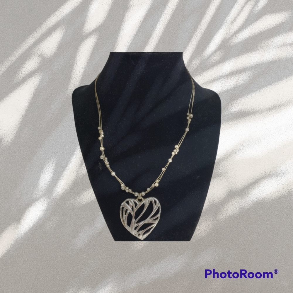 Metal necklace with beads and heart pendant